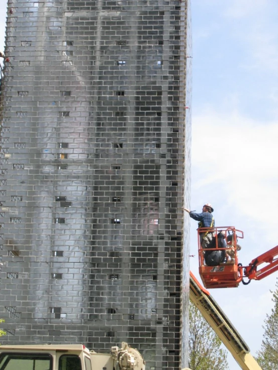 a crane lowering a giant building that's being renovated