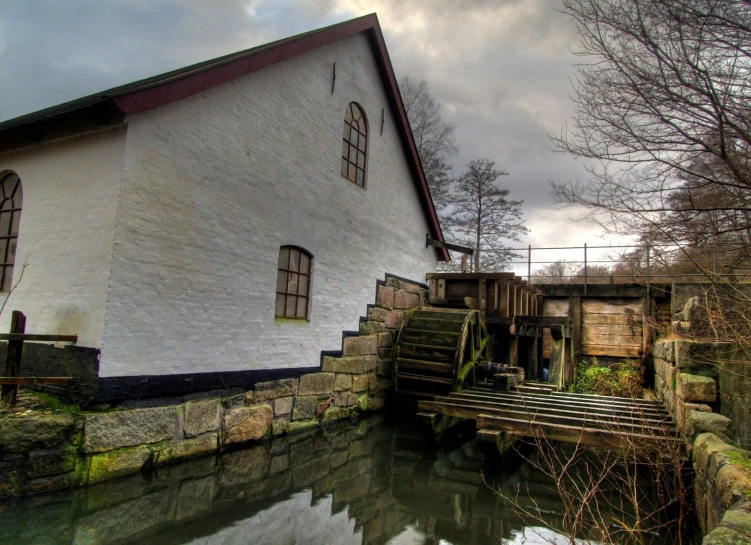 a large building sits next to some water