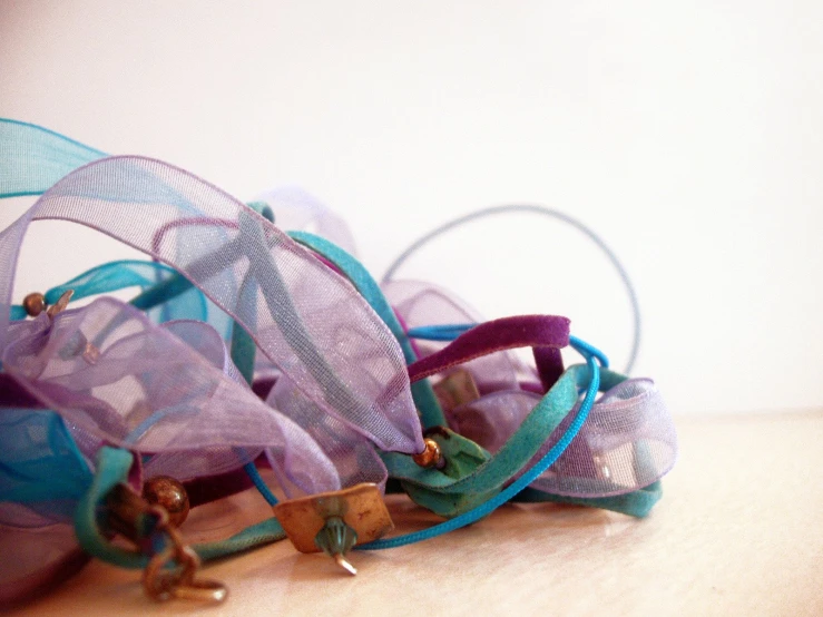 a pile of multi colored ribbons with handles