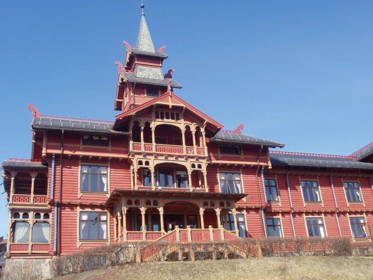 a large red building with a tower and a roof