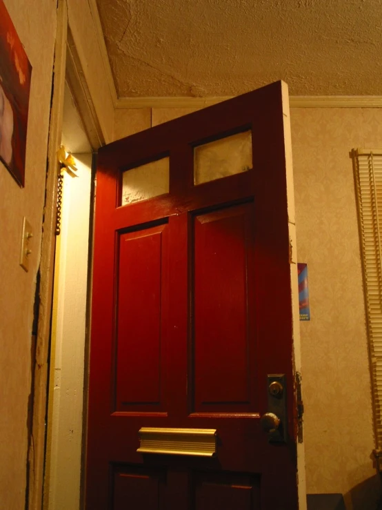 the front door of a residential building that is red