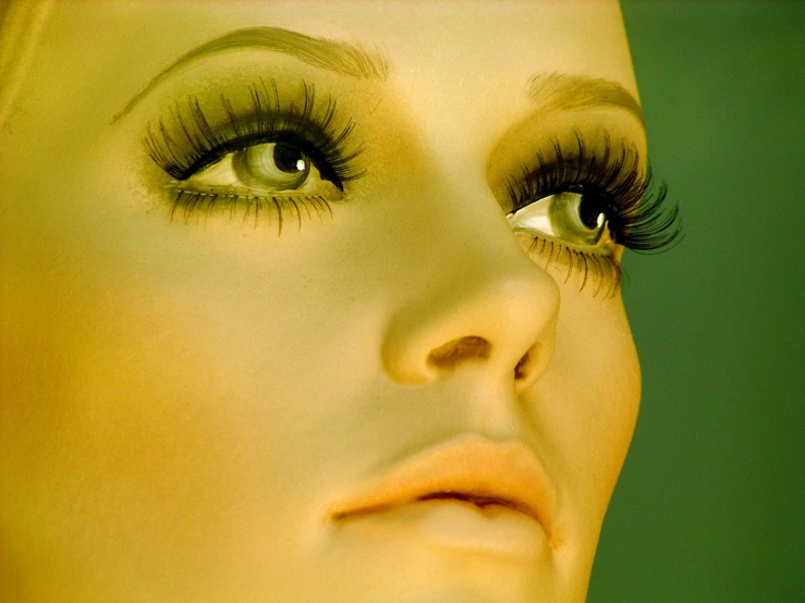 an extreme close up of a girl with eye makeup