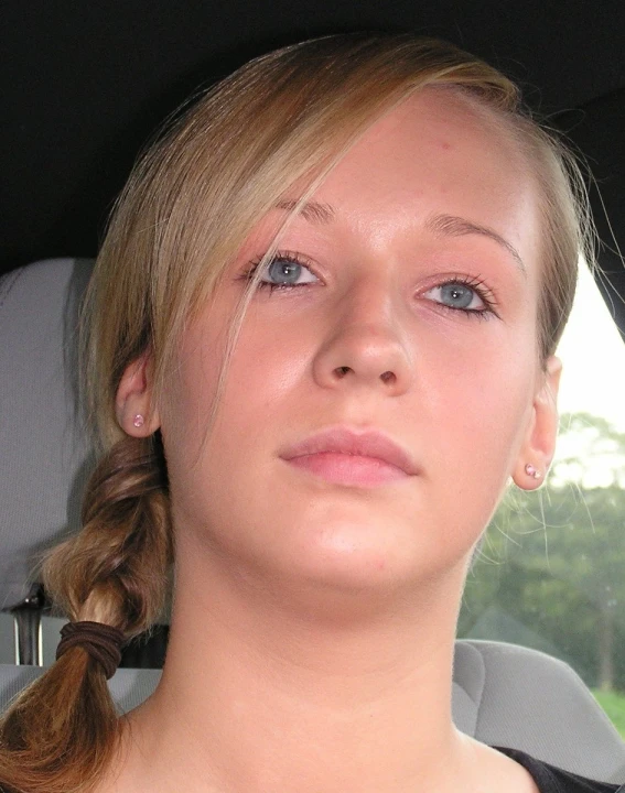 a pretty blonde woman sitting inside of a car