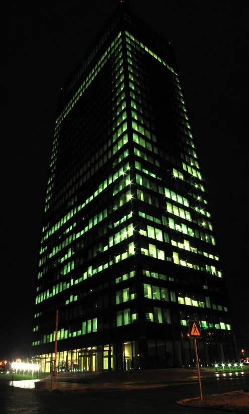 a large illuminated office building on the corner