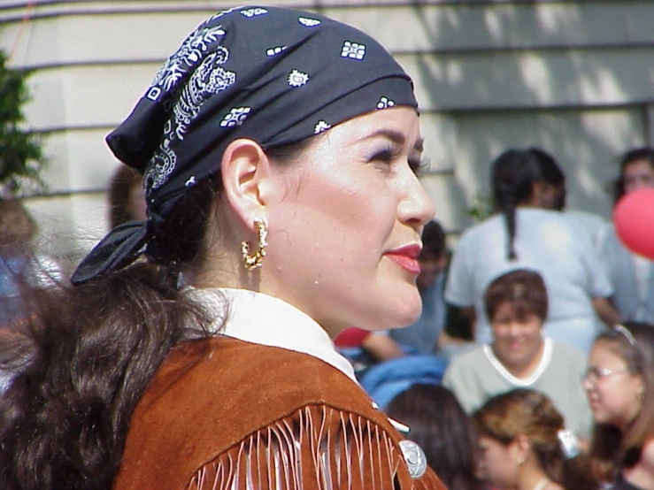 an asian woman in native wear at a parade
