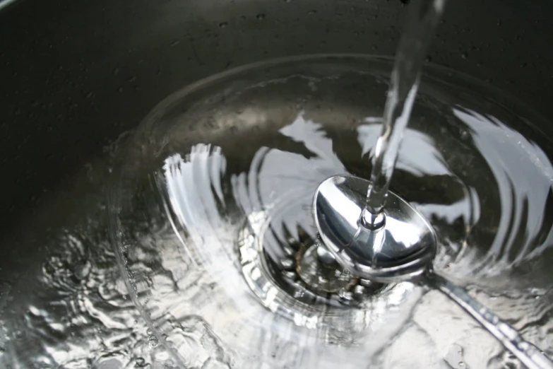 a large metal sink with a white faucet