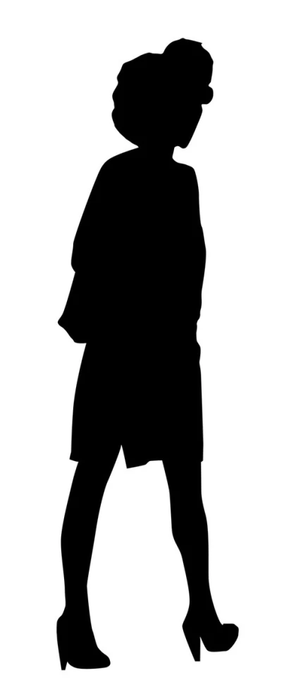 a woman walking down the street in silhouette