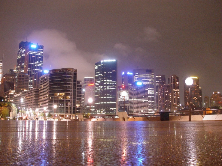 the view of city buildings from across a river at night