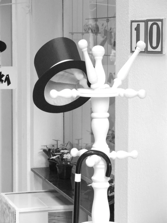 a black and white image of a table with top hat on it