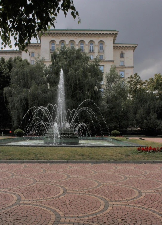 a large building with many windows and a water fountain