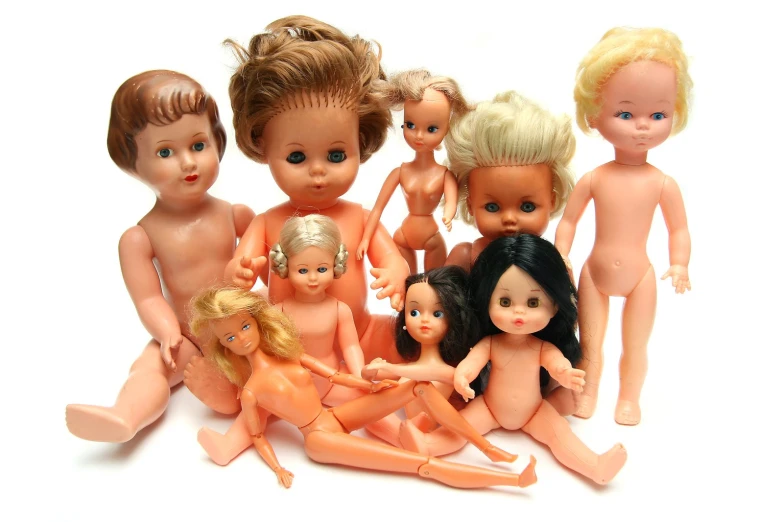 a group of  dolls with hair and makeup sitting next to each other