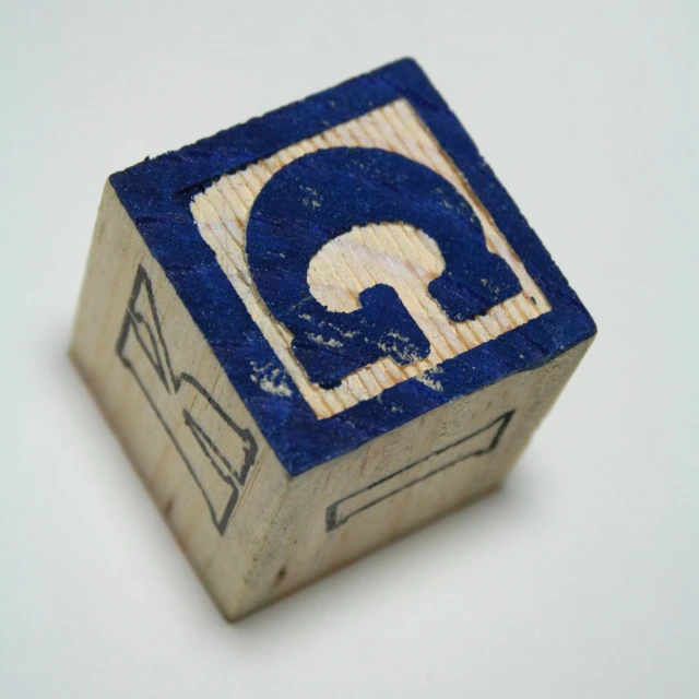 a wooden block with an arrow and a white background