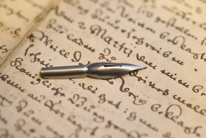 a pen that is laying on a paper with a writing technique