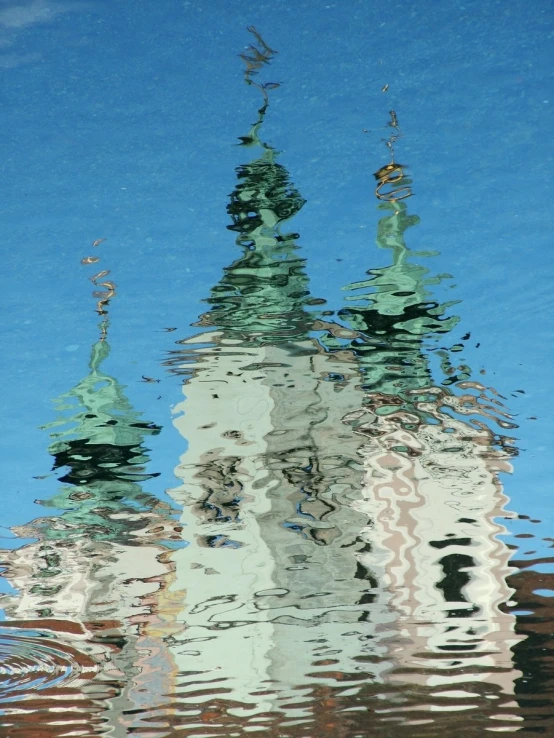 a big building is reflected in the water