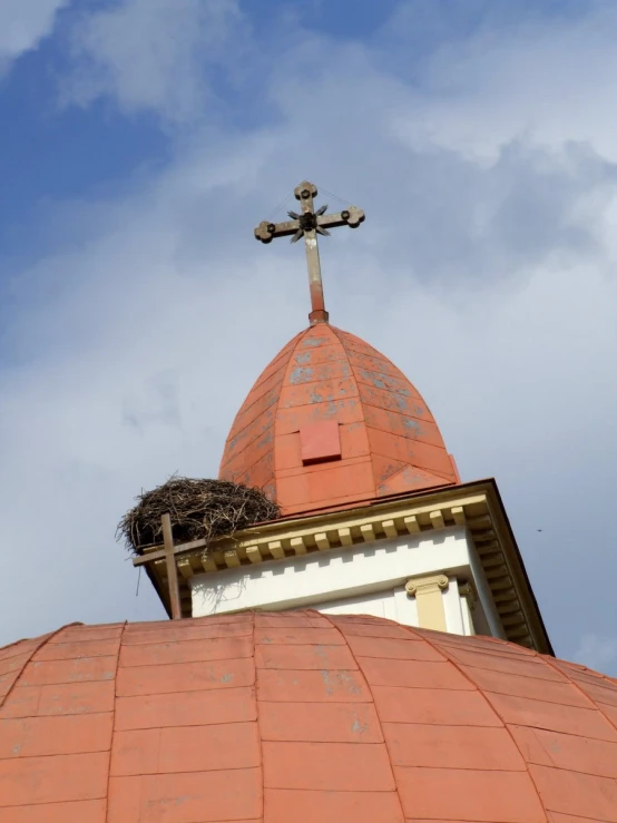 an ornate roof with a cross on top