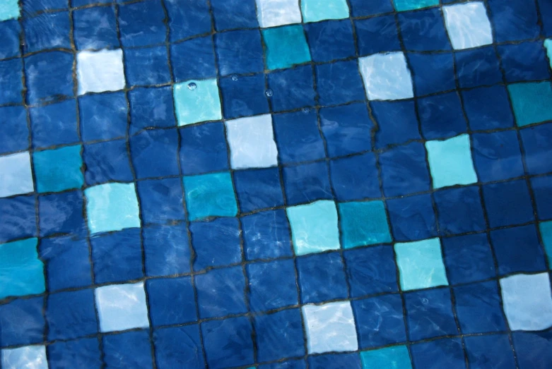 a close up of a blue tiled wall