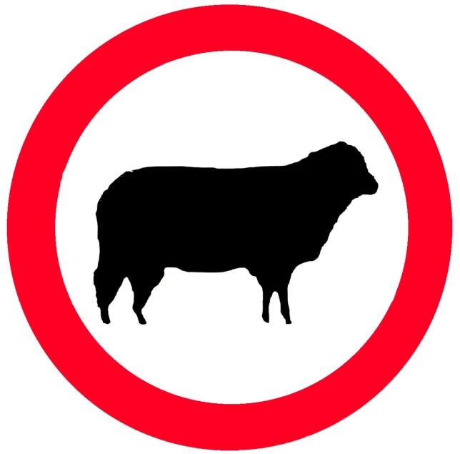 the silhouette of a black cow on red circle