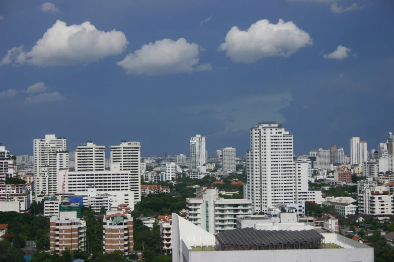 a city with tall buildings under cloudy skies