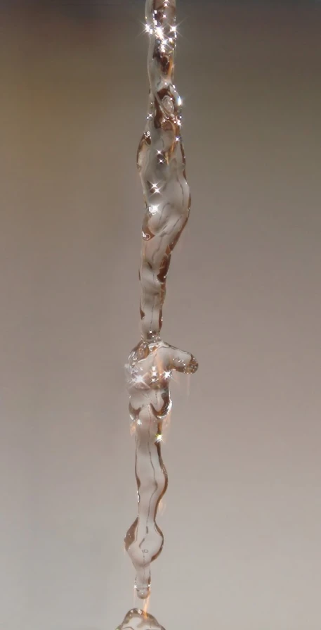 an artistic glass sculpture on a stand that appears to be suspended