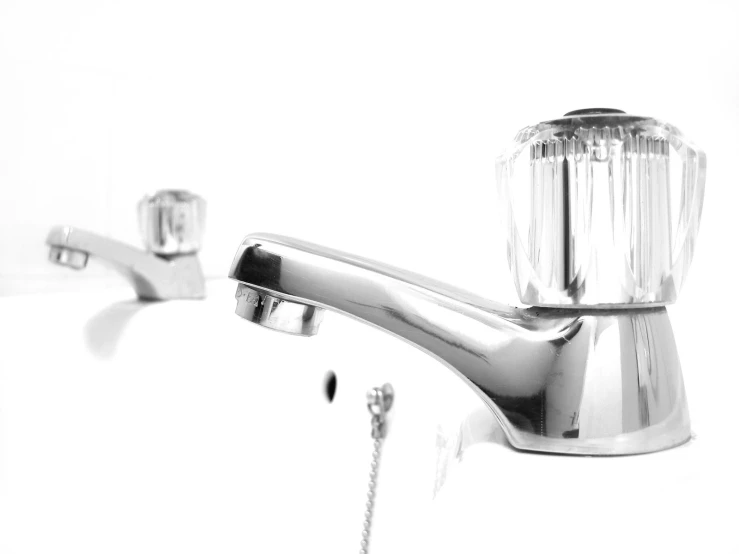 the kitchen faucet is shiny stainless steel