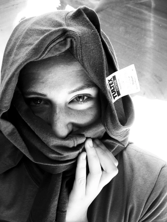 a young person posing for a pograph while wearing a hat and a veil