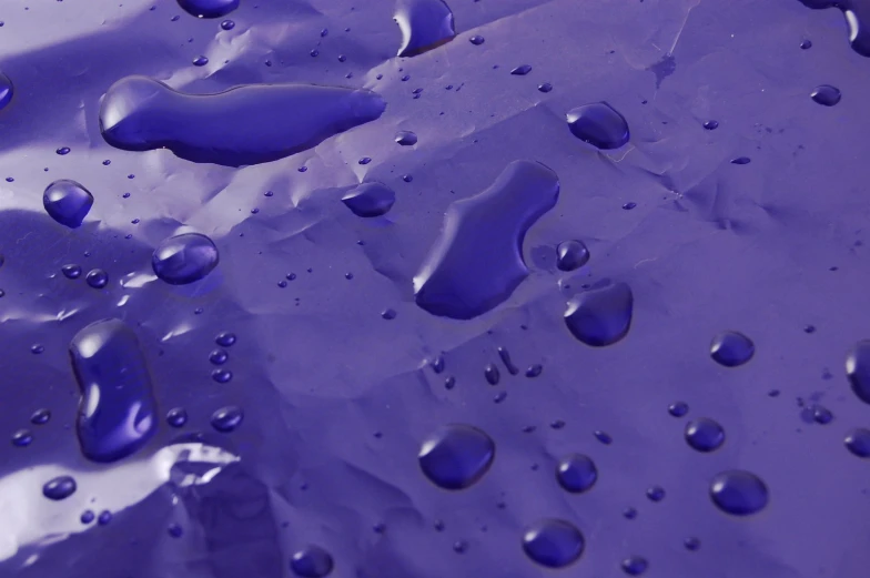 there is water drops and the surface has purple