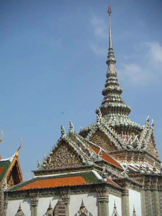 the top portion of a building is shown with a blue sky behind it