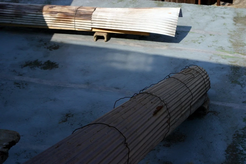 an old fence is laying next to a plank