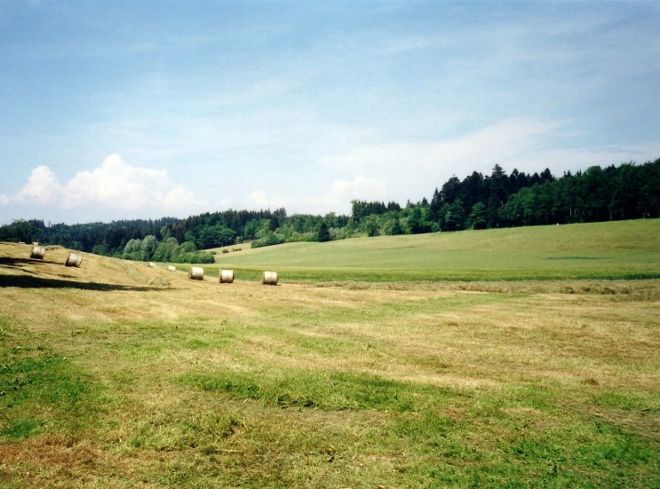 a wide open field filled with lots of hay