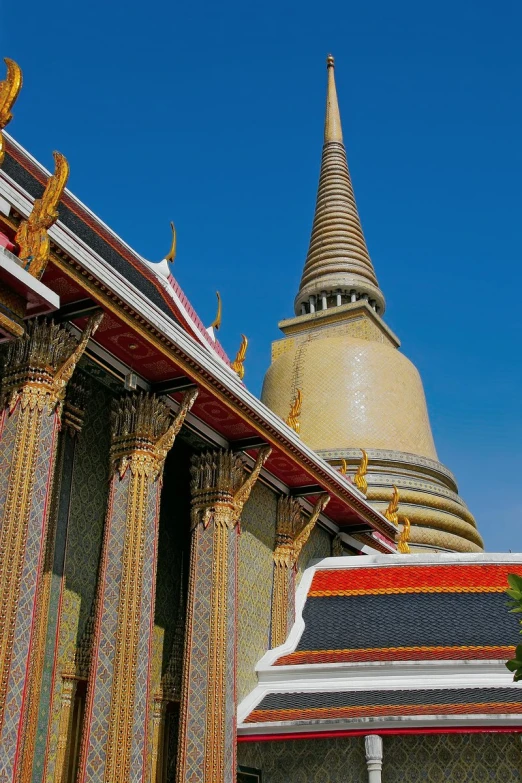 the tops of buddhist structures and some bushes