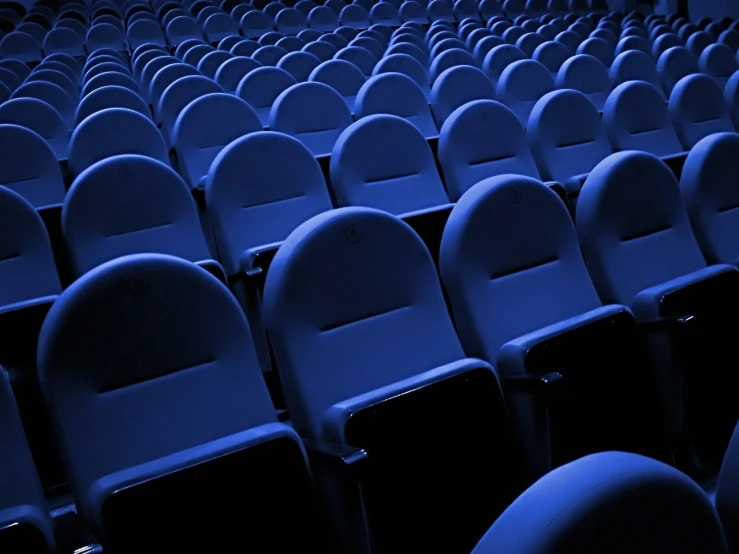 a large room filled with many white and black chairs