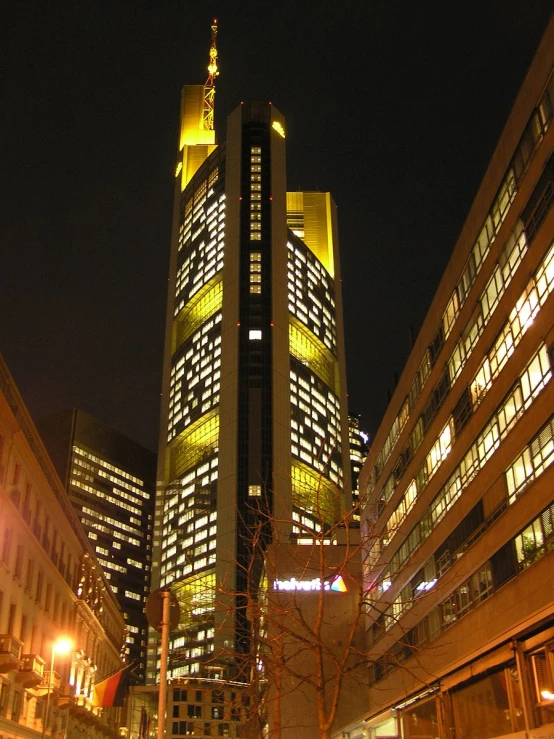 the tall buildings are illuminated at night time
