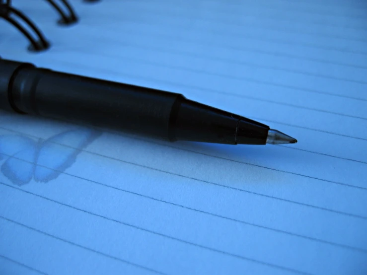 a black pen on top of a notebook