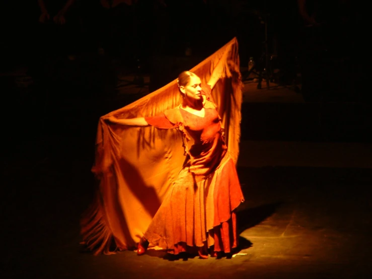 a woman in a dress with an orange fabric dd around her