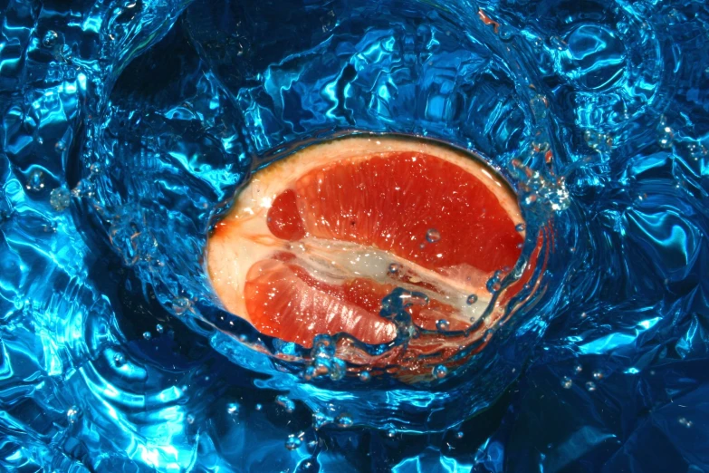 the fruit is cut in half on a blue surface