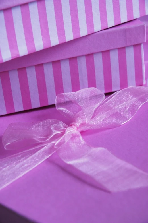 pink and white boxes with bows on them