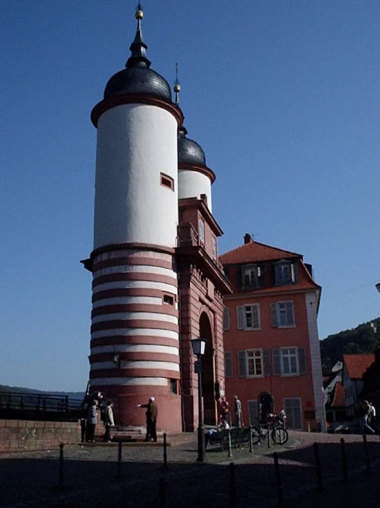 a tall tower sitting next to a wooden fence