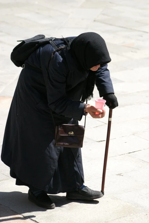 a woman is crouched down while holding onto her purse