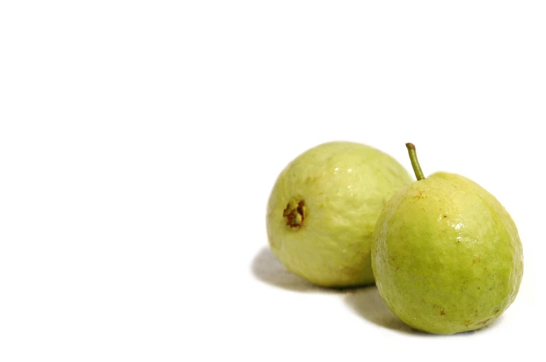 two green apples on a white background with space