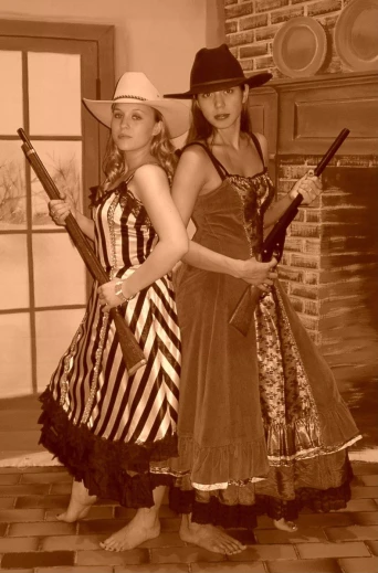 two girls dressed in dress like costumes, holding guns
