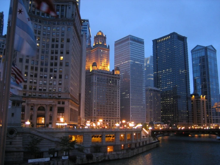 city skyline with lit up buildings and water