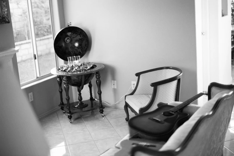 an elegant suite chair next to a round mirror