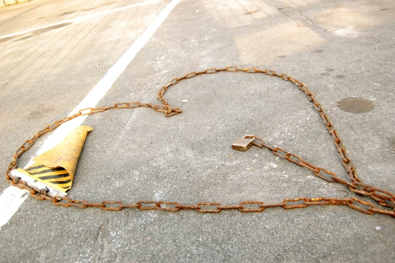 a chain is attached to a telephone cone and a key