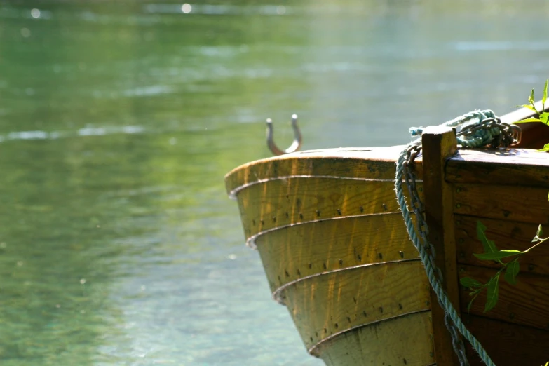 a wooden boat sitting next to the ocean