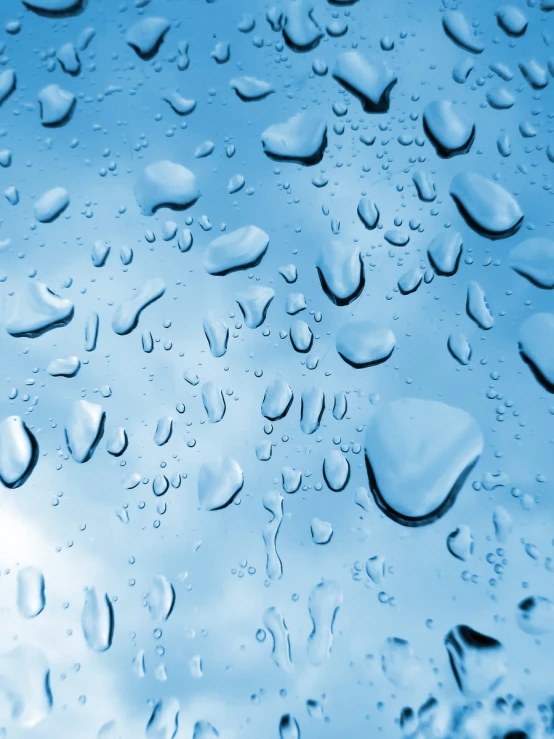 a closeup view of rain drops on the glass