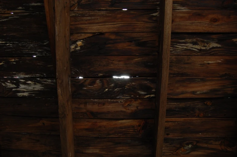 a bathroom that has some brown wood on it