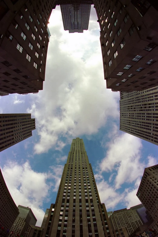 a upward view of some tall buildings with windows on them