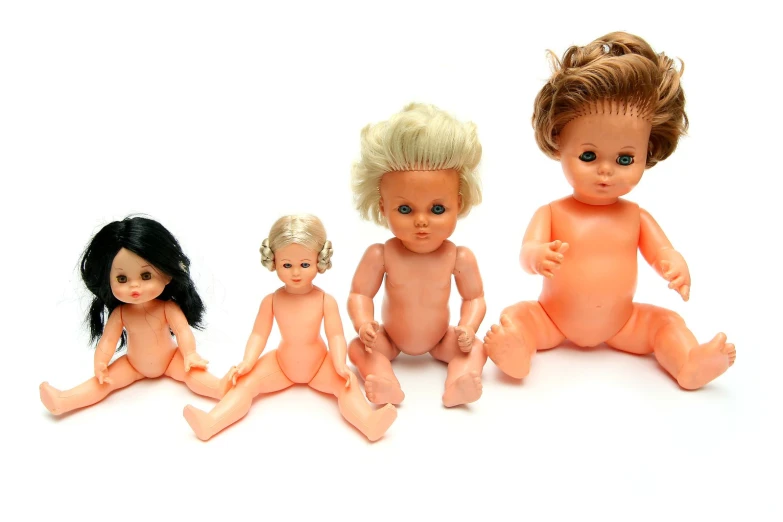 five baby dolls on white background, with small babies sitting side by side