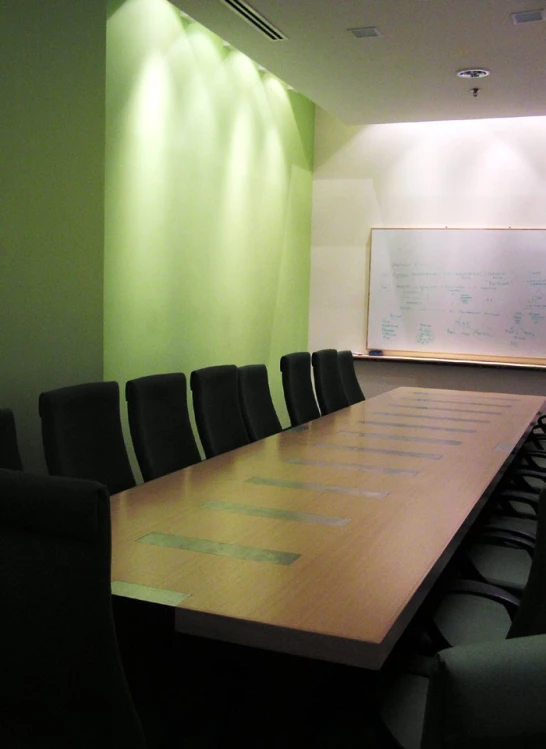 an empty meeting room set up with conference chairs and a board