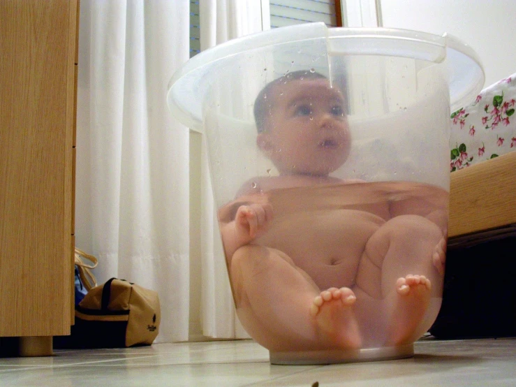 a  baby inside of a plastic container